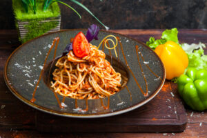 Side view pasta with tomato sauce on wooden table